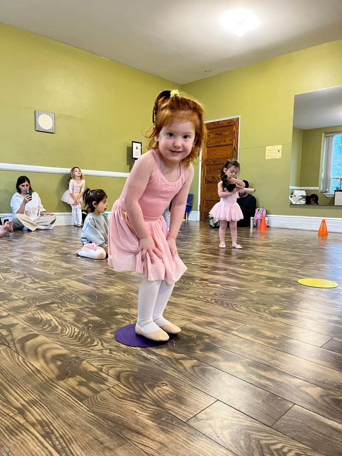 A toddler taking part in dance activities