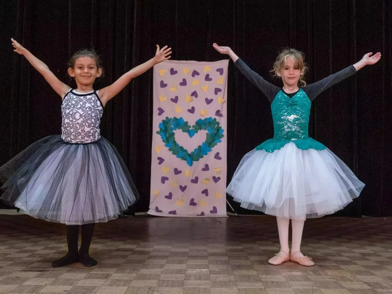 Two girls performing on stage after taking kids dance classes at a Toronto dance studio